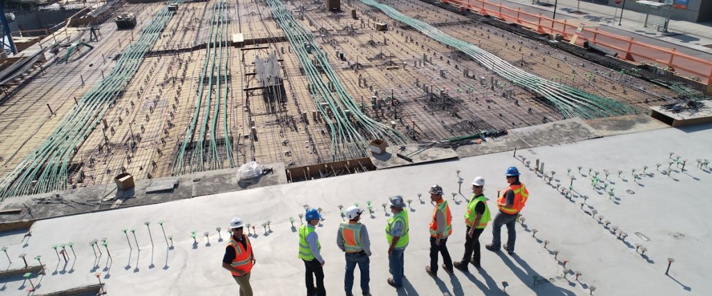 Construction site with workers discussing plans.