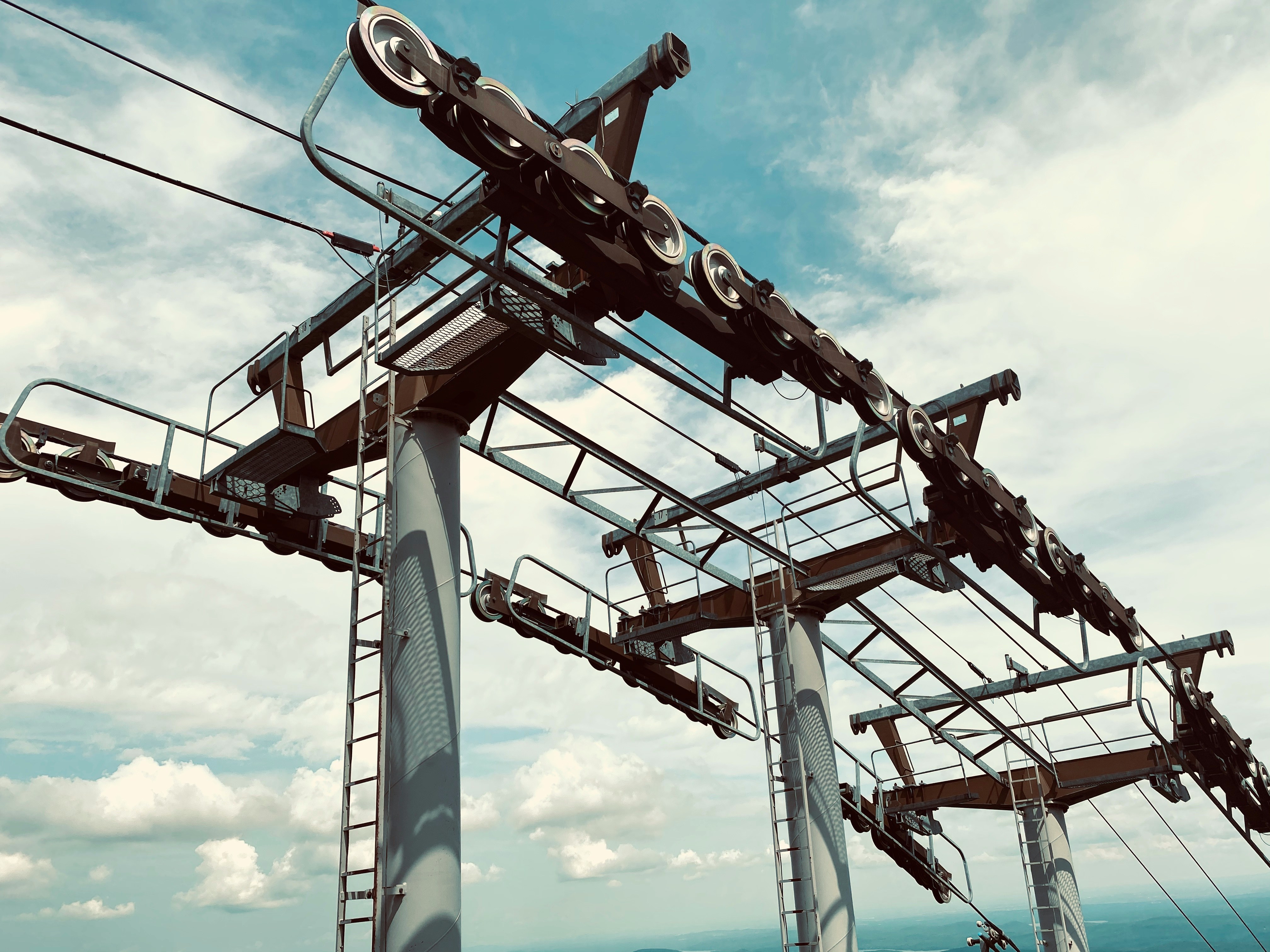 Ski lift machinery against cloudy sky